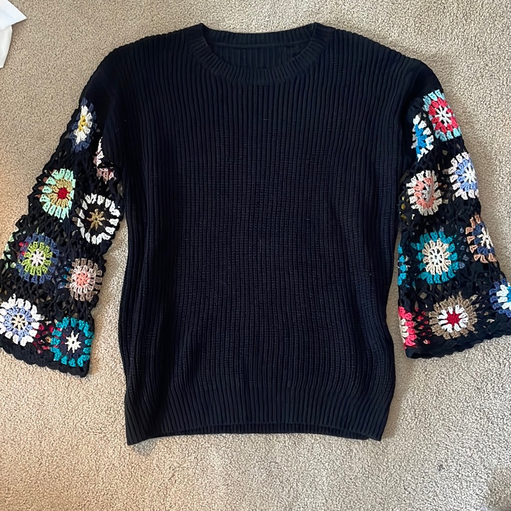 Black sweater with crochet flower detail